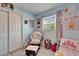 bedroom features a cozy chair and natural light from the window at 901 King St, Plant City, FL 33563