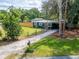 Charming home with a cozy front porch swing and well manicured garden and long driveway at 901 King St, Plant City, FL 33563