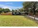 Charming home with a manicured lawn, covered carport, and inviting porch swing creates curb appeal at 901 King St, Plant City, FL 33563