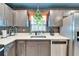 Bright kitchen with stainless steel dishwasher and refrigerator, features a garden window at 901 King St, Plant City, FL 33563