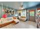 Comfortable living room with unique decor, cozy couches, and ample natural light creating a welcoming space at 901 King St, Plant City, FL 33563