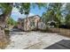 A spacious backyard with concrete parking area plus wooden fencing and access to the rear of the home at 933 E Shadowlawn Ave, Tampa, FL 33603