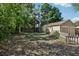 A backyard with the garage and mature trees create a private and shaded outdoor space at 933 E Shadowlawn Ave, Tampa, FL 33603