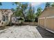 Spacious backyard featuring a detached garage and a deck, providing ample outdoor living and parking space at 933 E Shadowlawn Ave, Tampa, FL 33603