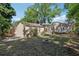 The expansive backyard features a firepit, garage, and a tranquil green space surrounded by mature trees at 933 E Shadowlawn Ave, Tampa, FL 33603