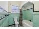 Quaint bathroom featuring a tub and shower combination with charming vintage tiling at 933 E Shadowlawn Ave, Tampa, FL 33603
