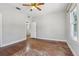 Bedroom with original hardwood floors, light grey walls, and connecting door to another room at 933 E Shadowlawn Ave, Tampa, FL 33603
