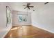 Bedroom featuring hardwood floors, two large windows, and neutral-colored walls at 933 E Shadowlawn Ave, Tampa, FL 33603