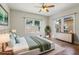 Spacious bedroom featuring a large bed, hardwood flooring, and plenty of natural light at 933 E Shadowlawn Ave, Tampa, FL 33603