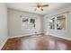 Bright bedroom featuring windows that let in natural light, hardwood floors, and a ceiling fan at 933 E Shadowlawn Ave, Tampa, FL 33603