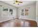Large bedroom with windows allowing plenty of natural light, hardwood floors, and a ceiling fan at 933 E Shadowlawn Ave, Tampa, FL 33603