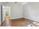 Bedroom featuring original hardwood floors and a connected bathroom through an open doorway at 933 E Shadowlawn Ave, Tampa, FL 33603