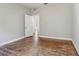 Bedroom with original floors, open doorway and large windows to let natural light flood the space at 933 E Shadowlawn Ave, Tampa, FL 33603