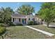 This home boasts a well-maintained front yard and a delightful exterior, with lovely lawn and inviting curb appeal at 933 E Shadowlawn Ave, Tampa, FL 33603