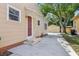 The house exterior features a classic design and a long driveway leading to a detached garage at 933 E Shadowlawn Ave, Tampa, FL 33603