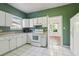 Kitchen featuring white appliances and cabinets with a window above the sink at 933 E Shadowlawn Ave, Tampa, FL 33603