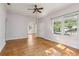 Bright living room features hardwood floors, two large windows, and white door at 933 E Shadowlawn Ave, Tampa, FL 33603