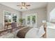 A primary bedroom featuring lots of light, ceiling fan and hardwood flooring at 933 E Shadowlawn Ave, Tampa, FL 33603