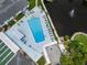 Overhead shot features community pool, shuffleboard, pond with fountain, and lounge chairs for residents at 10008 Daffodil N St # 186, Pinellas Park, FL 33782