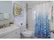 Bright bathroom features a vanity, toilet, tub and shower with blue accents at 10008 Daffodil N St # 186, Pinellas Park, FL 33782