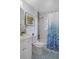 Bright bathroom features a vanity, toilet, tub and shower with blue accents at 10008 Daffodil N St # 186, Pinellas Park, FL 33782