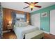 Bright bedroom with wood paneled accent wall, ensuite bath, and ample closet space at 10008 Daffodil N St # 186, Pinellas Park, FL 33782