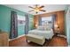 Charming bedroom with wood paneled accent wall, ensuite bath, and ample natural light at 10008 Daffodil N St # 186, Pinellas Park, FL 33782