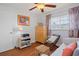 Bedroom features a dresser, chair and woven storage, naturally lit with wood-look flooring at 10008 Daffodil N St # 186, Pinellas Park, FL 33782
