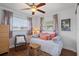 Cozy bedroom is naturally lit, with wood-look flooring and decorative accents at 10008 Daffodil N St # 186, Pinellas Park, FL 33782