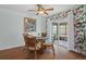 Bright dining area featuring a glass table and wicker chairs with a view to the screened in porch at 10008 Daffodil N St # 186, Pinellas Park, FL 33782
