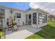 Exterior view of sunroom, backyard and patio chairs on the rear of the property at 10008 Daffodil N St # 186, Pinellas Park, FL 33782