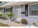 Inviting front porch with decorative plants, stylish chairs, and a charming 'HOME' welcome mat at 10008 Daffodil N St # 186, Pinellas Park, FL 33782