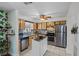 Updated kitchen boasts stainless steel appliances, stylish backsplash, and functional island at 10008 Daffodil N St # 186, Pinellas Park, FL 33782
