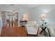 Inviting living room with a peek into the dining area, featuring hardwood floors and stylish decor at 10008 Daffodil N St # 186, Pinellas Park, FL 33782