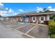 Exterior view of the office with brick facade, well-kept landscaping, and blue awning over the entrance at 10008 Daffodil N St # 186, Pinellas Park, FL 33782