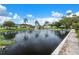 Inviting community pond with fountain, palms, and waterside walking path at 10008 Daffodil N St # 186, Pinellas Park, FL 33782