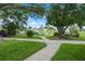 Scenic community pond with fountain, lush greenery, and inviting benches for relaxation at 10008 Daffodil N St # 186, Pinellas Park, FL 33782