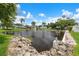 Scenic community pond with fountain, lush palms, and waterfront views enhancing the tranquil setting at 10008 Daffodil N St # 186, Pinellas Park, FL 33782