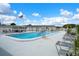 Outdoor pool surrounded by lounge chairs, showcasing a relaxed and inviting community space with US flag at 10008 Daffodil N St # 186, Pinellas Park, FL 33782