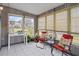 Enclosed sunroom features tiled floors, neutral walls, and views of the lawn at 10008 Daffodil N St # 186, Pinellas Park, FL 33782