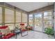 Enclosed sunroom features tiled floors, neutral walls, and views of the lawn at 10008 Daffodil N St # 186, Pinellas Park, FL 33782