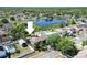 Aerial view of the beautiful home, pool, deck, and picturesque pond at 10404 Crestfield Dr, Riverview, FL 33569