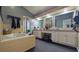Modern bathroom with double sinks, a soaking tub, and sleek fixtures at 10404 Crestfield Dr, Riverview, FL 33569
