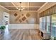 Formal dining room with elegant decor, coffered ceiling, wainscoting, and ample natural light at 10404 Crestfield Dr, Riverview, FL 33569