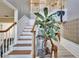 Inviting foyer with staircase, wood accents, and decorative animal sculptures at 10404 Crestfield Dr, Riverview, FL 33569
