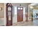 Inviting front entrance features a wood door with sidelights and a charming 'The Edquist's' doormat at 10404 Crestfield Dr, Riverview, FL 33569