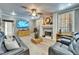 Inviting living room featuring a cozy fireplace, modern ceiling fan, and comfortable leather seating at 10404 Crestfield Dr, Riverview, FL 33569