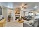 Bright living room with fireplace, ceiling fan, hardwood floors, and access to kitchen at 10404 Crestfield Dr, Riverview, FL 33569