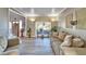 Bright living room boasts large window, cozy seating, and neutral tones at 10404 Crestfield Dr, Riverview, FL 33569
