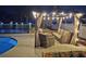 Inviting outdoor lounge area featuring comfortable wicker furniture under a pergola with string lights near the pool at 10404 Crestfield Dr, Riverview, FL 33569